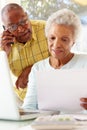 Worried Senior Couple Using Laptop At Home Royalty Free Stock Photo