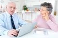 Worried senior couple using laptop at home Royalty Free Stock Photo