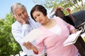 Worried Senior Hispanic Couple Checking Mailbox Royalty Free Stock Photo