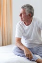 Worried senior man sitting on bed Royalty Free Stock Photo