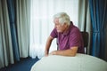 Worried senior man sitting in living room Royalty Free Stock Photo