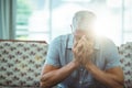 Worried senior man sitting in living room Royalty Free Stock Photo