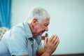 Worried senior man sitting in living room Royalty Free Stock Photo