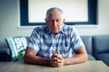 Worried senior man sitting in living room Royalty Free Stock Photo