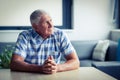 Worried senior man sitting in living room Royalty Free Stock Photo