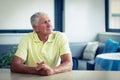 Worried senior man sitting in living room Royalty Free Stock Photo