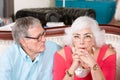 Concerned Senior Man and Woman Embracing