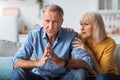 Senior Wife Talking To Concerned Husband Having Problems Indoors