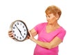 Worried senior woman holding big clock Royalty Free Stock Photo