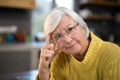 Worried senior woman in the kitchen Royalty Free Stock Photo