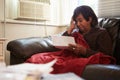 Worried Senior Woman Sitting On Sofa Looking At Bills Royalty Free Stock Photo