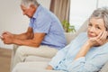 Worried senior woman sitting on sofa Royalty Free Stock Photo