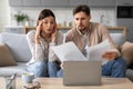 Worried spouses reviewing documents with laptop on the table Royalty Free Stock Photo