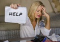 Worried and stressed Caucasian 40s woman holding notepad calculating domestic expenses and taxes payments in budget problem and fi Royalty Free Stock Photo