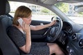 Worried and stressed woman driving car while talking on the mobile phone distracted Royalty Free Stock Photo