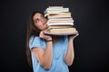 Worried student girl holding a pile of books Royalty Free Stock Photo