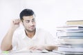 Worried student looking books on white background