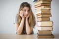 Worried student looking at books