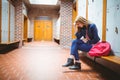 Worried student sitting with hand on head