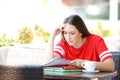 Worried student trying to understand lesson in a coffee shop