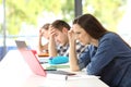 Worried students doing difficult work on line Royalty Free Stock Photo