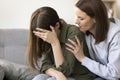 Worried sympathetic mom hugging crying teenager kid