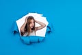 worried teen girl on blue background, copy space, problem