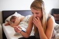 Worried Teenage Girl In Bedroom With Pregnancy Tes