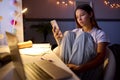 Worried Teenage Girl Sitting At Desk In Bedroom At Home Looking At Mobile Phone At Night Royalty Free Stock Photo