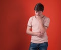 Worried teenager in beige t shirt standing and looking away Royalty Free Stock Photo