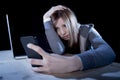 Worried teenager using mobile phone and computer as internet cyber bullying stalked victim abused Royalty Free Stock Photo