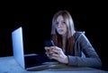 Worried teenager using mobile phone and computer as internet cyber bullying stalked victim abused Royalty Free Stock Photo