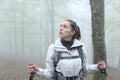 Worried trekker looking at side in a foggy forest