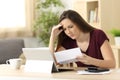 Worried woman calculating accountancy reading a letter Royalty Free Stock Photo