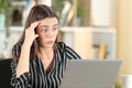 Worried woman discovering error on laptop Royalty Free Stock Photo