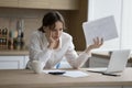 Worried woman feels shocked due to heap of unpaid bills Royalty Free Stock Photo