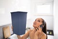 Woman Holding Bucket While Water Droplets Leak From Ceiling Royalty Free Stock Photo