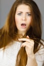 Worried woman looking at her dry hair ends Royalty Free Stock Photo