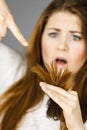 Worried woman looking at her dry hair ends Royalty Free Stock Photo