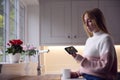 Worried Woman Looking At Smart Meter In Kitchen At Home During Cost Of Living Energy Crisis Royalty Free Stock Photo