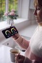 Worried Woman Looking At Smart Meter In Kitchen At Home During Cost Of Living Energy Crisis Royalty Free Stock Photo