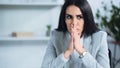 worried woman with praying hands near Royalty Free Stock Photo