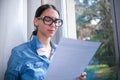 Concept of money problems. Woman's worried expression and the letter in her hand suggest a financial crisis Royalty Free Stock Photo