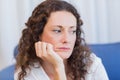 Worried woman sitting on the couch