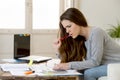 Worried woman suffering stress doing domestic accounting paperwork bills and invoices Royalty Free Stock Photo