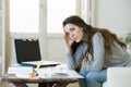 Worried woman suffering stress doing domestic accounting paperwork bills and invoices