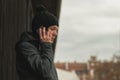 Worried woman talking on mobile phone on street Royalty Free Stock Photo