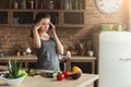 Worried woman talking on phone in home kitchen Royalty Free Stock Photo