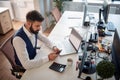 Worried young business man texting on his cell phone. men, modern, office, business, bad news concept