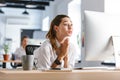 Worried young businesswoman sitting at her workplace at the office Royalty Free Stock Photo